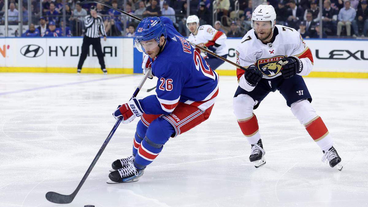 May 22, 2024; New York, New York, USA; New York Rangers forward Jimmy Vesey plays the puck against Florida Panthers defenseman Dmitry Kulikov (7) during the third period of game one of the Eastern Conference Final of the 2024 Stanley Cup Playoffs at Madison Square Garden.
