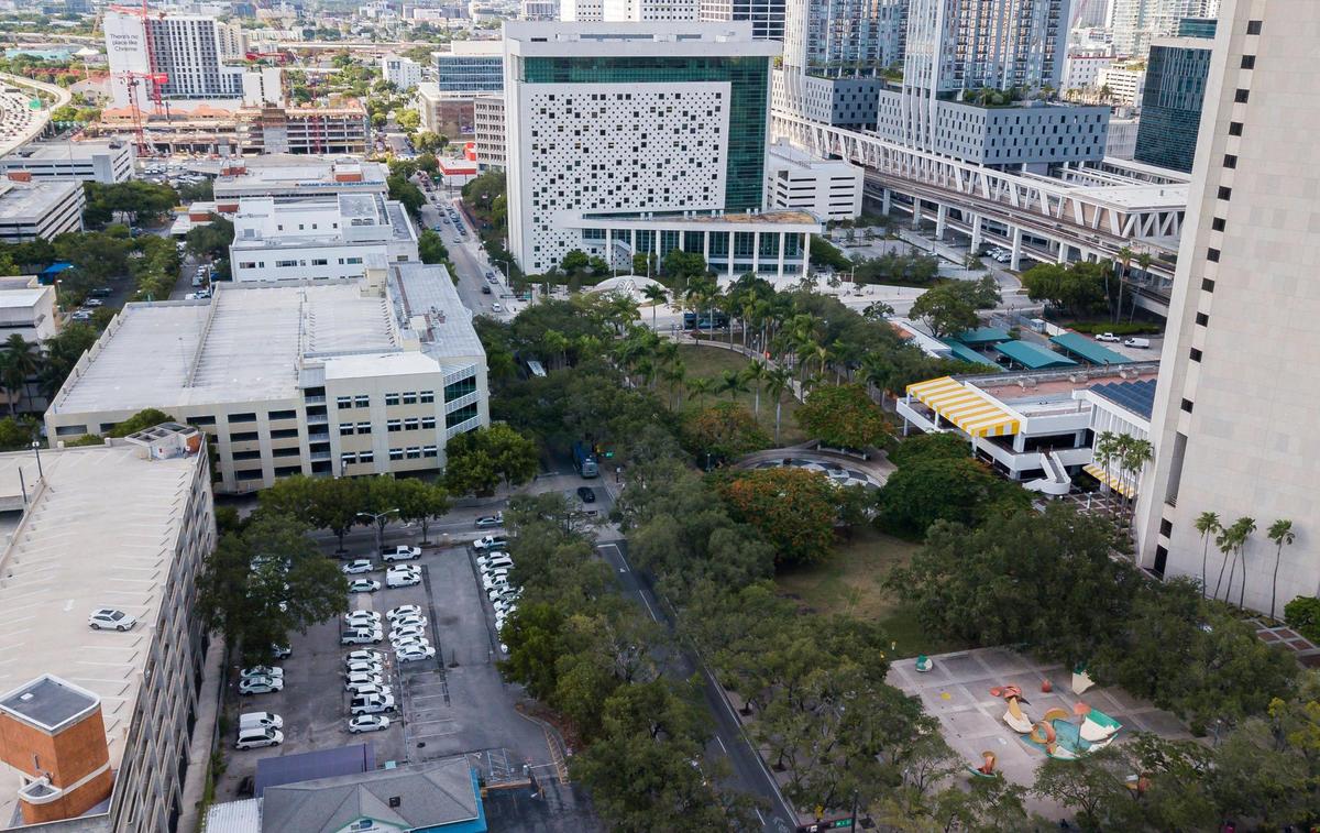 Miami-Dade County is offering public land and buildings surrounding its Stephen P. Clark Government Center tower, right, to developers to form a new downtown neighborhood. The property up for bid includes the green space and annex buildings surrounding the tower as well as the garage and county motorpool facility at lower left. The tower would remain. Claes Oldenburg and Coosje van Bruggen’s “Dropped Bowl with Scattered Slices and Peels” sculpture, lower right, would be moved elsewhere.
