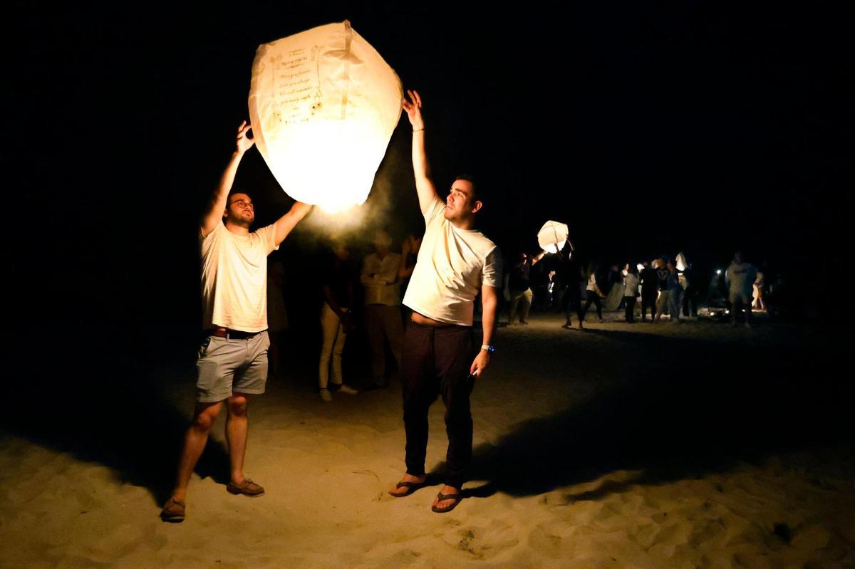 Daniel Urgelles and Sebastian Gonzalez release a lantern to honor Mercedes and Raymond Urgelles who died during the collapse of Champlain Towers South in Surfside, Florida. Family, friends, and survivors gathered on the beach to honor the 98 lives lost on the two-year anniversary at 1:22 AM on Saturday, June 24, 2023.