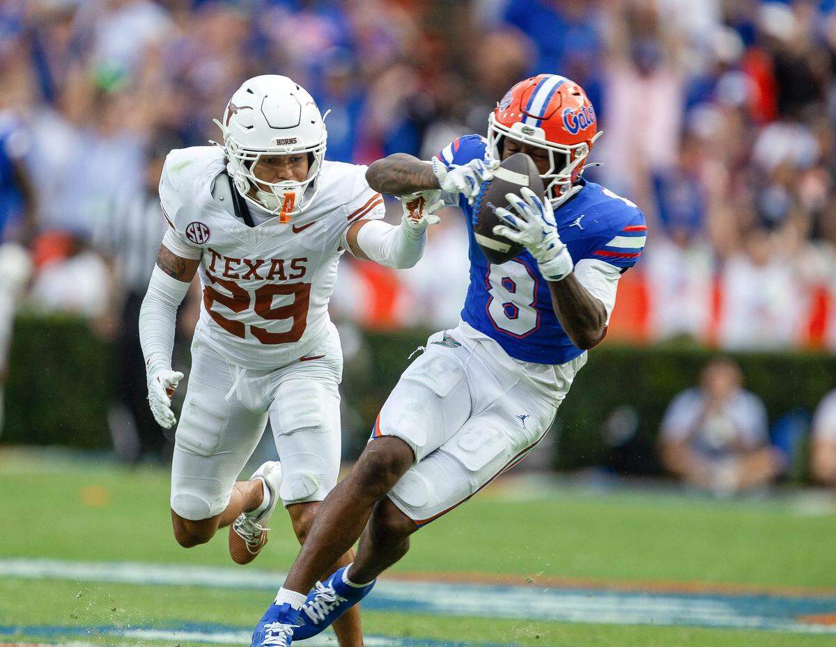 Florida wide receiver Vernell Brown III (8) hauls in a pass under pressure from Texas defensive back Graceson Littleton (29) during the second half an NCAA football game in Gainesville, FL on Saturday, October 4, 2025. [Alan Youngblood/Gainesville Sun]