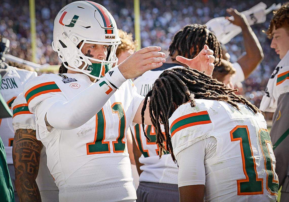Miami Hurricanes quarterback Carson Beck (11) crowns wide receiver Malachi Toney (10) in the bench area after Toney scores the winning touchdown to defeat the Texas A&M Aggies in the second half of the first round of the 2025 College Football Playoff at Kyle Field at College Station, Texas, on Saturday, December 20, 2025.