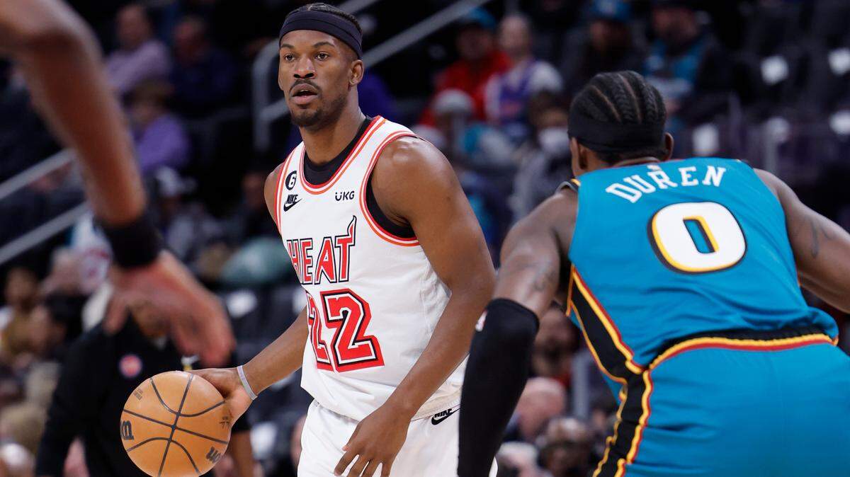 Apr 4, 2023; Detroit, Michigan, USA; Miami Heat forward Jimmy Butler (22) dribbles defended by Detroit Pistons center Jalen Duren (0) in the first half at Little Caesars Arena. Mandatory Credit: Rick Osentoski-USA TODAY Sports