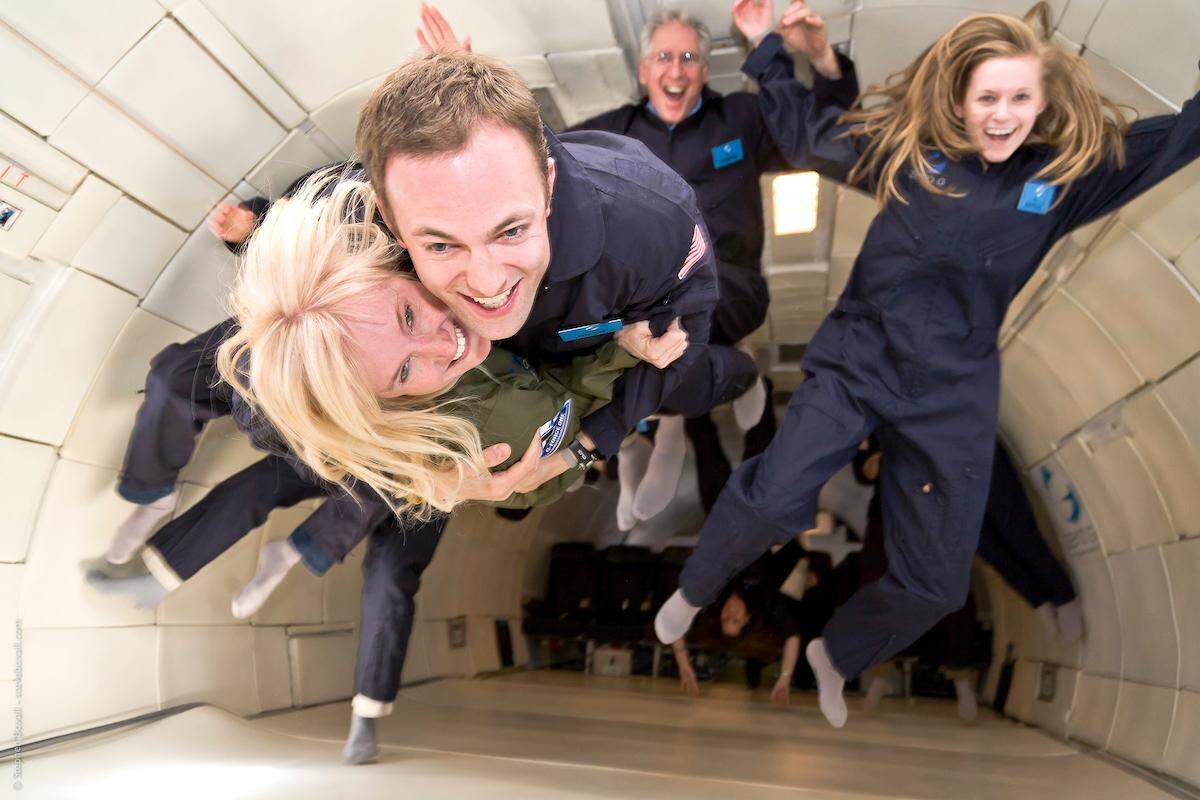 Passengers pose for photos aboard Zero-G’s zero gravity flight.