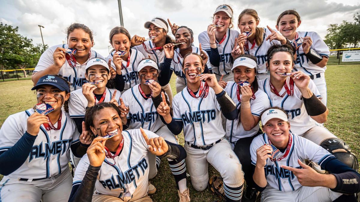 The Palmetto softball team celebrates after beating Coral Reef 4-2 in GMAC championship game.