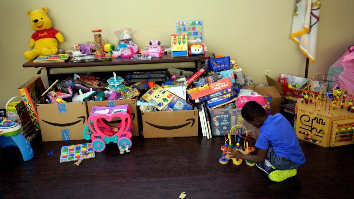 A young immigrant who was recently reunited with his family plays with toys at a Catholic Charities facility, Wednesday, July 18, 2018, in San Antonio.  CEO Antonio Fernandez said Tuesday that his staff and volunteers have served around 20 families reunited after being separated under the U.S. government’s zero-tolerance policy for unauthorized border crossers.