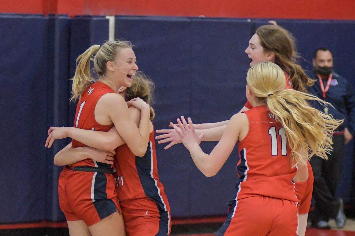 Members of the Westminster Academy girls’ basketball team celebrate after defeating Miami Country Day in the Region 4-3A final on Friday, Feb. 18, 2022.