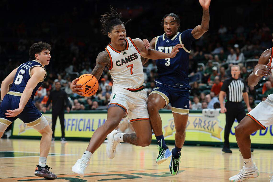 Miami Hurricanes forward Shelton Henderson (7) drives to the basket against FIU Panthers forward Corey Stephenson (3) during the first half at Watsco Center on Tuesday, Dec. 16, in Coral Gables, Fla.