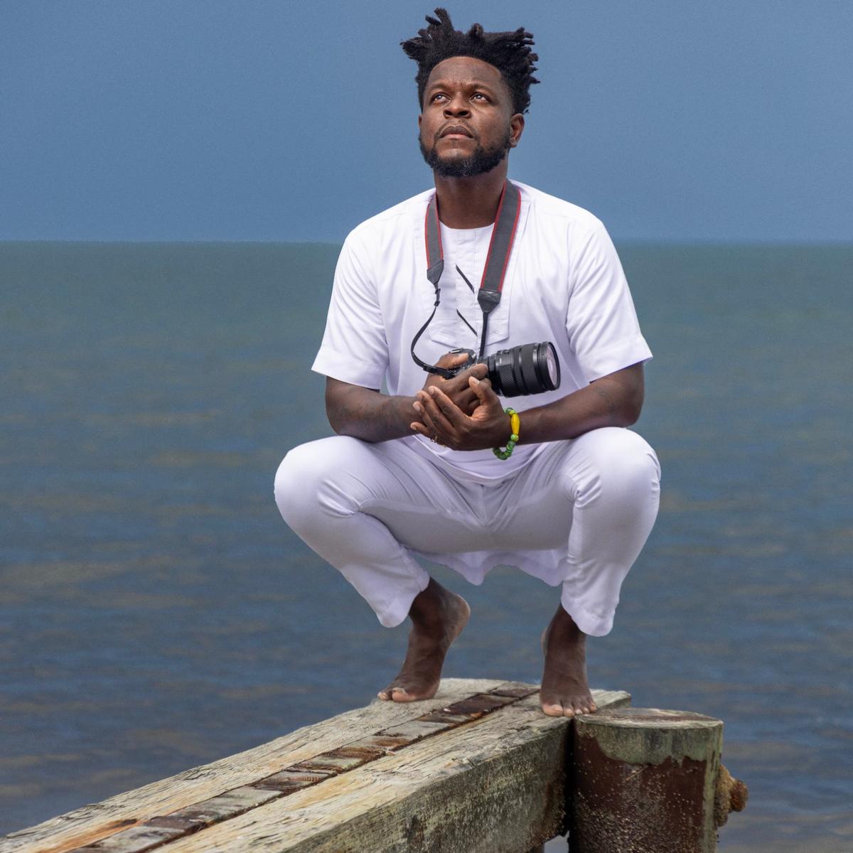 Woosler Delisfort positions himself near the shoreline at the Historic Virginia Key Beach Park. His new show at the HistoryMiami museum, “SANCTUARY: Our Sacred Place,” documents the spiritual origins of Miami’s Indigenous, African, and Caribbean communities.