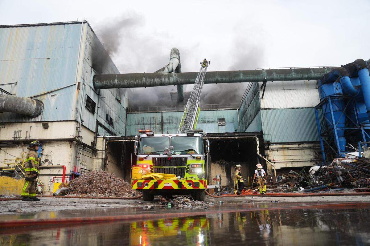 Miami-Dade firefighters work to extinguish the fire at the Covanta waste-incinerator plant in Doral on Sunday, Feb. 12, 2023.