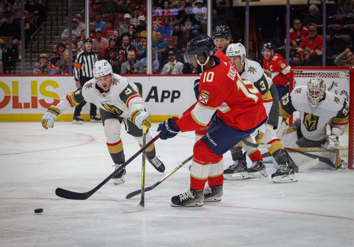 Vegas Golden Knights center Jack Eichel (9) tries to take the puck from Florida Panthers left wing Anthony Duclair (10) during the first period of a NHL game between the Florida Panthers and the Vegas Golden Knights on Tuesday, March 7, 2023, at FLA Live Arena.