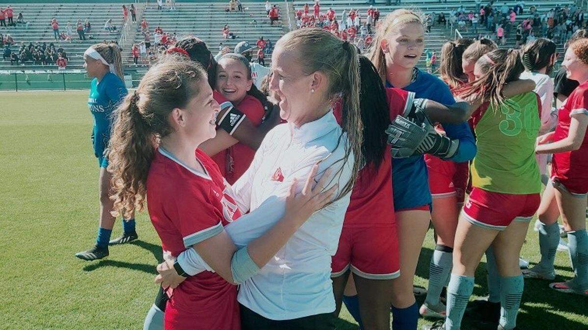 Gibbons coach Margo Flack celebrates with freshman Juliana Torres after the Chiefs won their first state championship in girls’ soccer on Wednesday in DeLand.