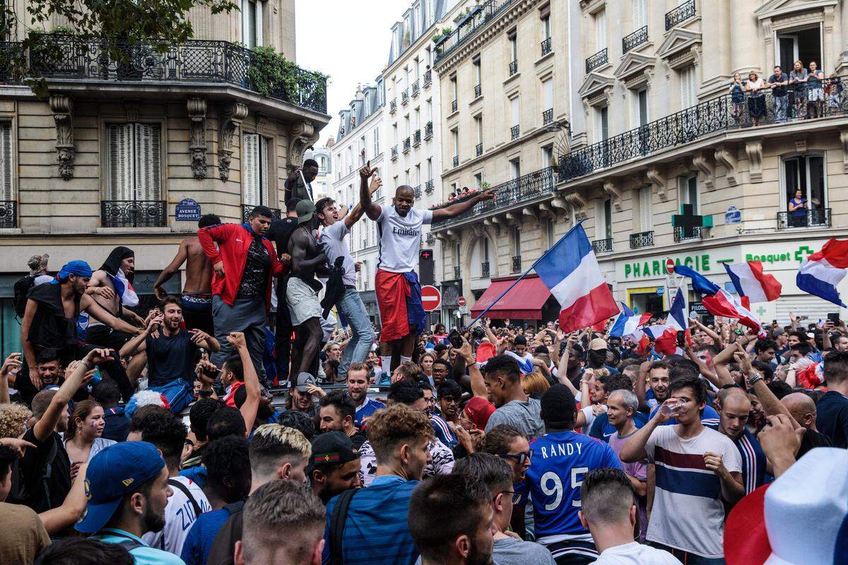 PARIS, FRANCE - JULY 15: French football fans celebrate in the street after France's victory against Croatia in the World Cup Final on July 15, 2018 in Paris, France. France beat Croatia 4-2 in the World Cup Final played at Moscow's Luzhniki Stadium today. (Photo by Jack Taylor/Getty Images)