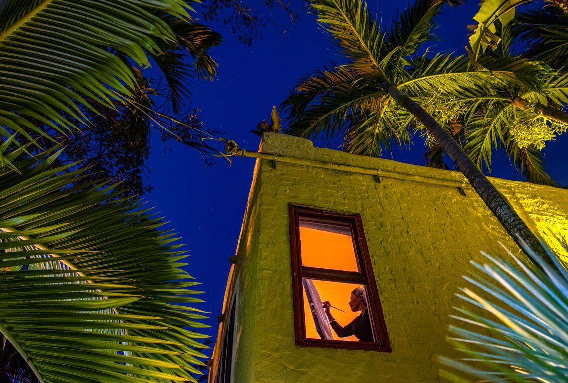 Artist Lisa Remeny works into the twilight hours as she practices social distancing while painting “Moonlight on the coast” at her Coconut Grove home during the coronavirus pandemic on Wednesday, April 1, 2020.