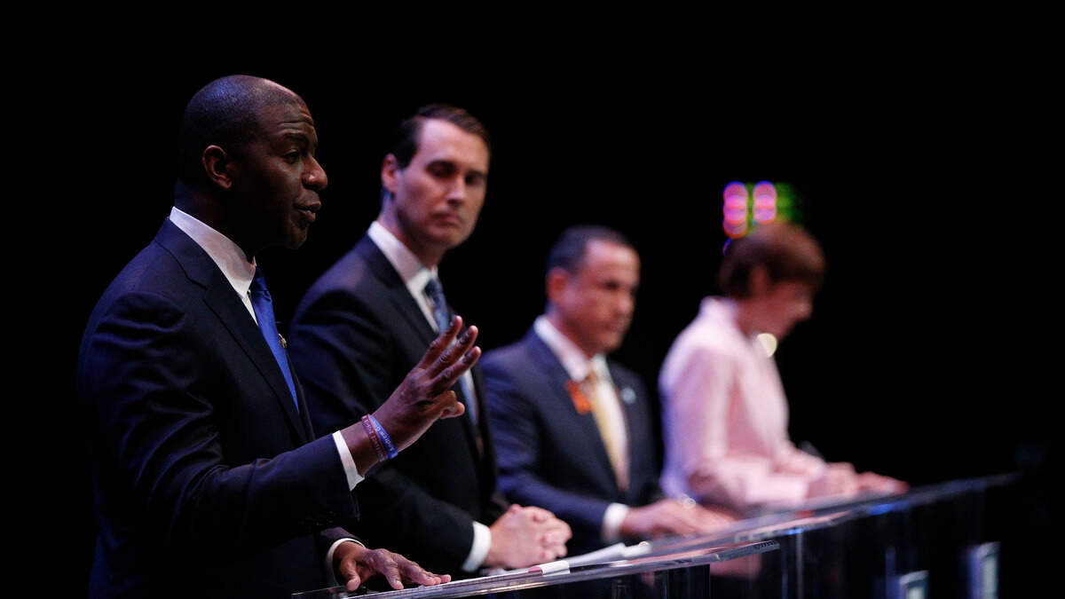 Tallahassee Mayor Andrew Gillum, left, speaks as businessman Chris King, Miami Beach Mayor Philip Levine and U.S. Rep. Gwen Graham listen during a gubernatorial debate ahead of the Democratic primary for governor on Monday, June 11, 2018, in Miramar. Fla.
