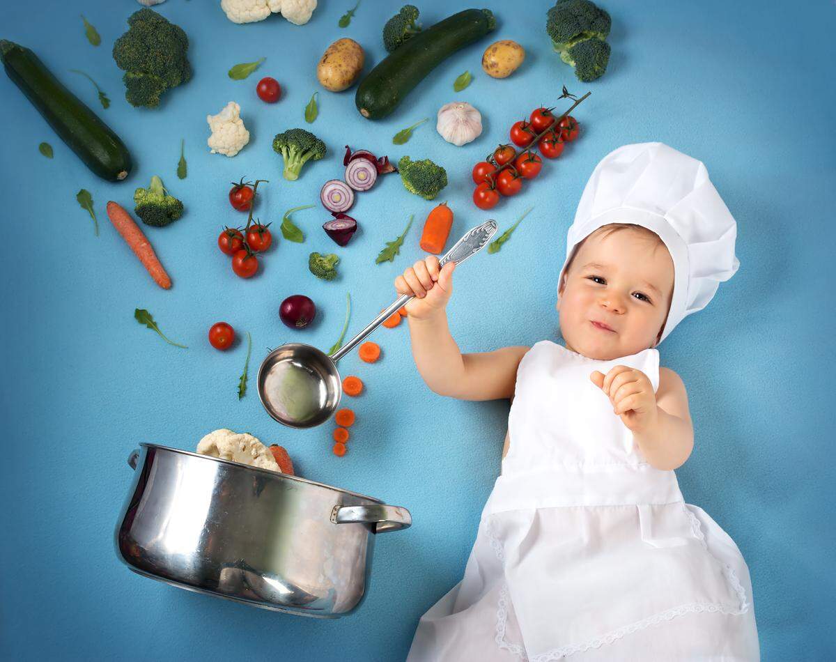 baby chef with ingredients and a pot