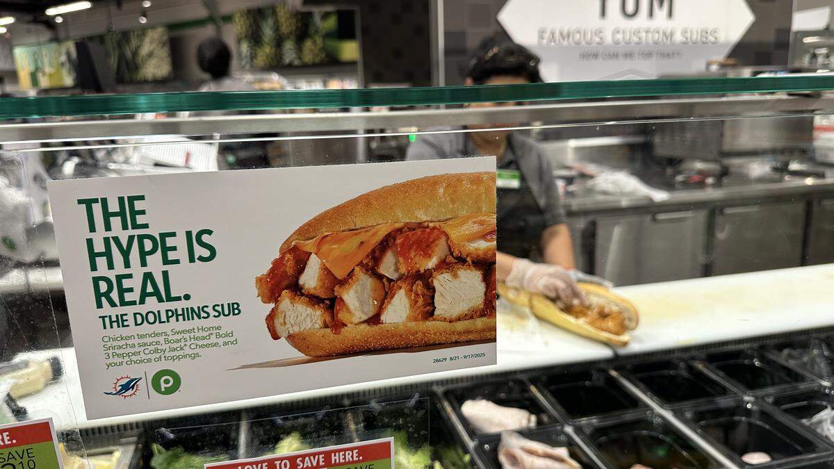 A Publix deli staffer dresses up a new Dolphins Sub with its newest ingredient for the 2025 NFL season, chicken tenders, at the Briar Bay Publix near The Falls in Miami-Dade on Sept. 7, 2025.