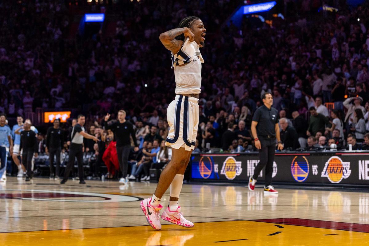 Memphis Grizzlies guard Ja Morant (12) reacts after hitting a game-winning buzzer beater to defeat the Miami Heat 110-108 during the second half of an NBA game at Kaseya Center on April 3, 2025, in Miami.