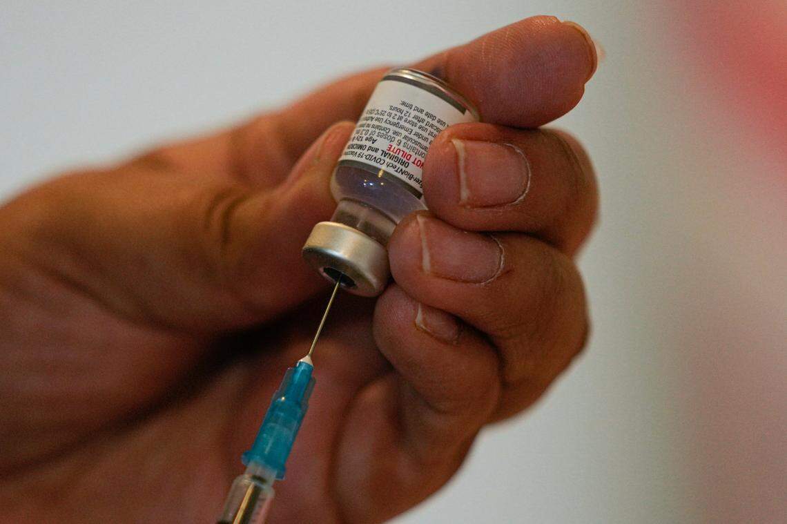 A healthcare worker prepares a dose of the COVID-19 bivalent booster at the start of a vaccination campaign for people 80 years and older, in Santiago, Chile, on Wednesday, Oct. 26, 2022.