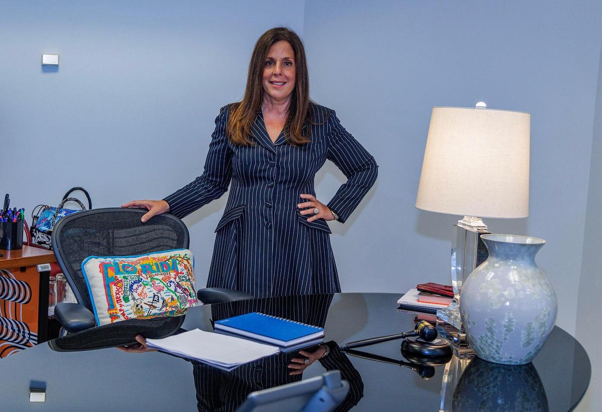 Attorney Yvette Ostolaza, management committee chair with the multinational law firm Sidley Austin in Miami, stands in her office, on Thursday Sept. 21, 2023.