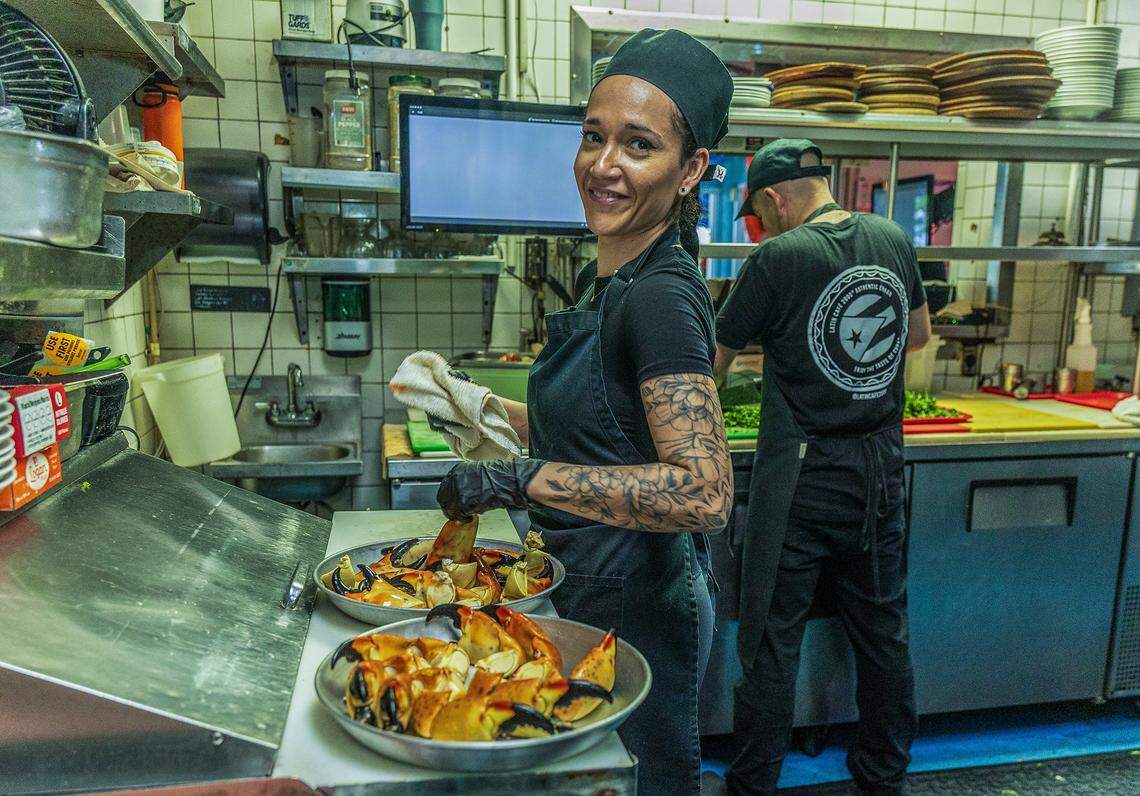 Chef Angela Castellanos prepares a couple Stone Crab trays, in the kitchen ahead of the beginning of the Stone Crab season at the iconic Catch of the Day Restaurant on Lejeune Avenue in Miami, on Tuesday October, 14 2025.