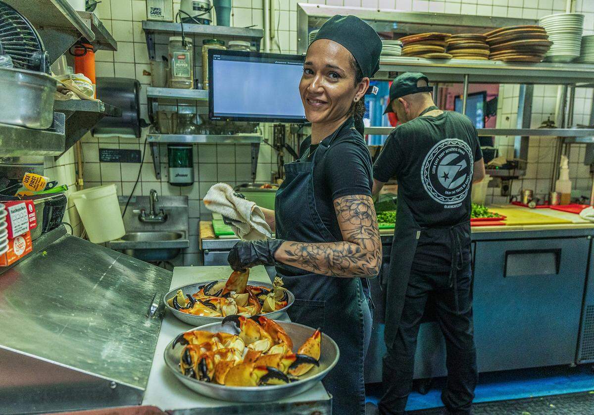 Chef Angela Castellanos prepares a couple Stone Crab trays, in the kitchen ahead of the beginning of the Stone Crab season at the iconic Catch of the Day Restaurant on Lejeune Avenue in Miami, on Tuesday October, 14 2025.