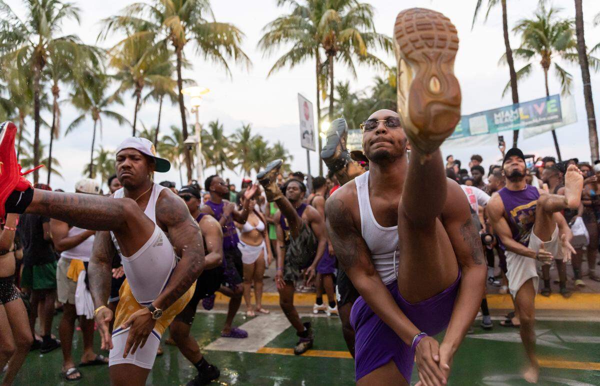 Santana Melvin II, right, dances with fellow members of Alpha Delta Eta of Omega Psi Phi on Ocean Drive during spring break on Saturday, March 11, 2023, in Miami Beach, Fla.