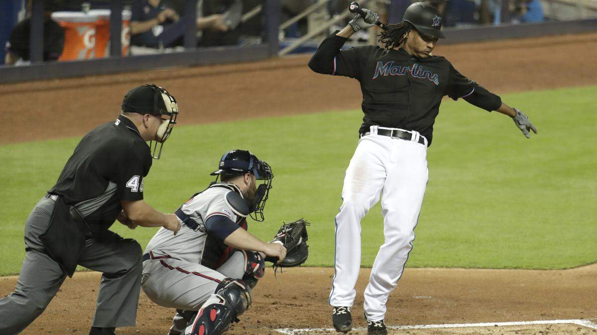 Miami Marlins’ Jose Urena, right, moves away from a close pitch thrown by Atlanta Braves starter Kevin Gausman during the second inning of a baseball game Friday, May 3, 2019, in Miami. Gausman was ejected on the play. At center is Braves catcher Brian McCann.