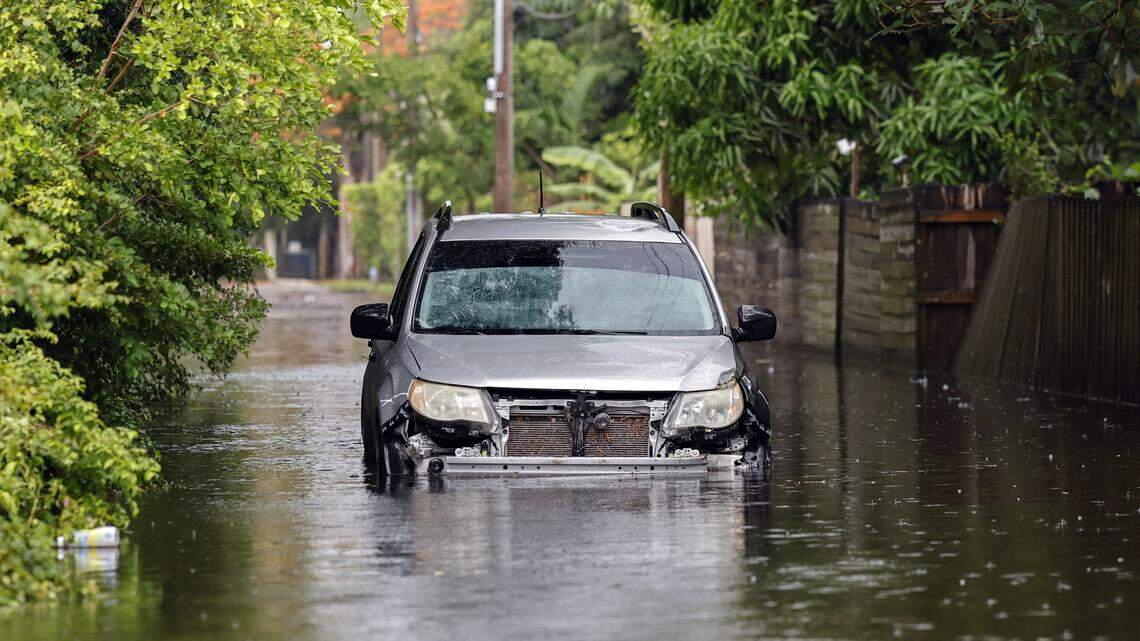An abandoned vehicle is seen along a flooded street in a residential area of North Miami, Florida near NE 123 street on Thursday, June 13, 2024.
