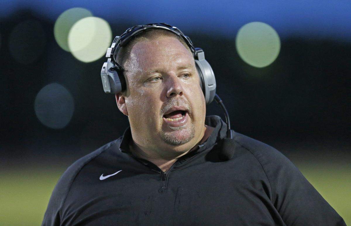 North Marion High School Coach Stephen Field on the field as Booker T. Washington hosts North Marion at Traz Powell Stadium in a preseason game on Friday, August 21, 2015.