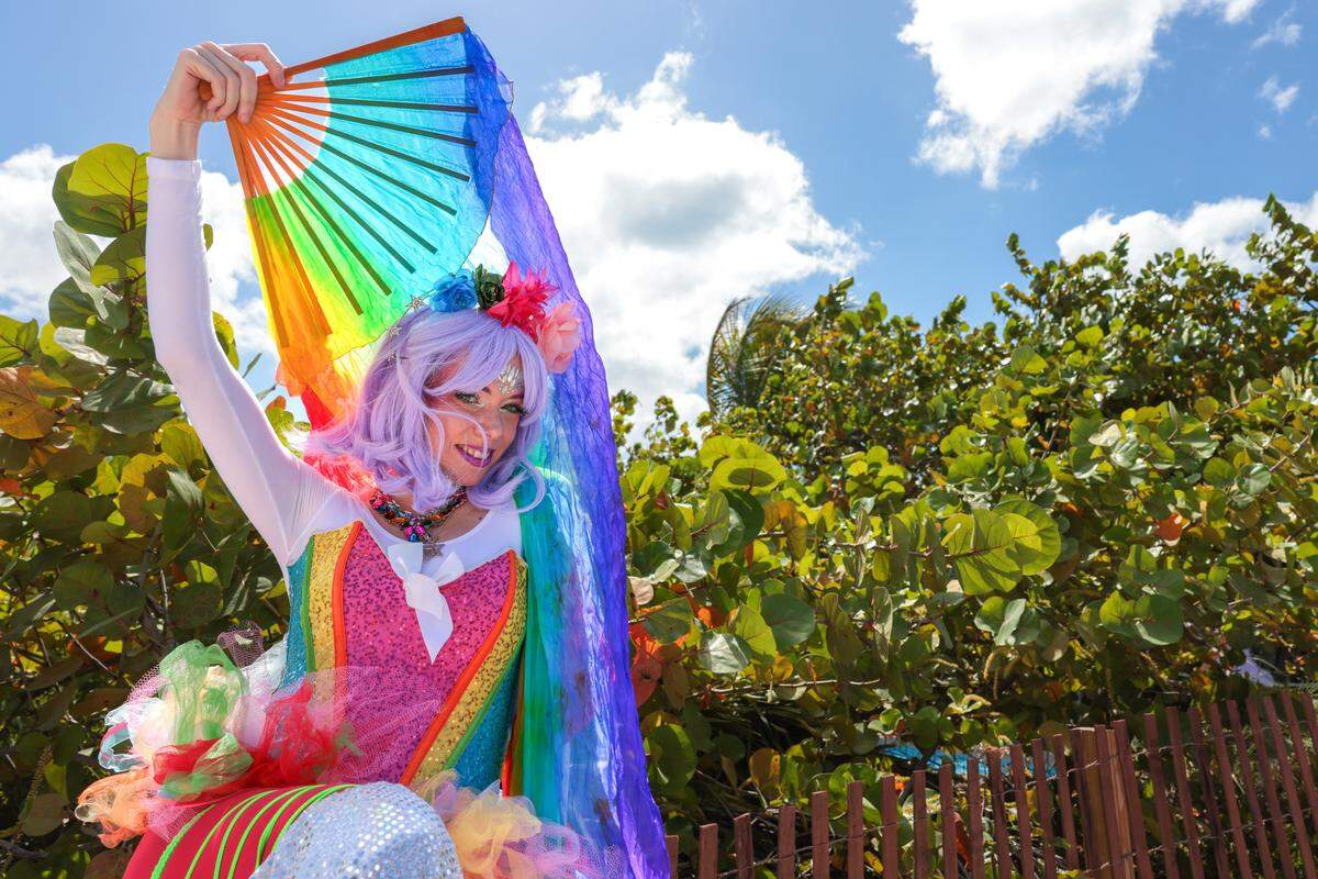 Mesodi Bergman poses for a photo before walking down Ocean Drive during the 18th annual pride parade in Miami Beach, Florida, Sunday, April 12, 2026. 