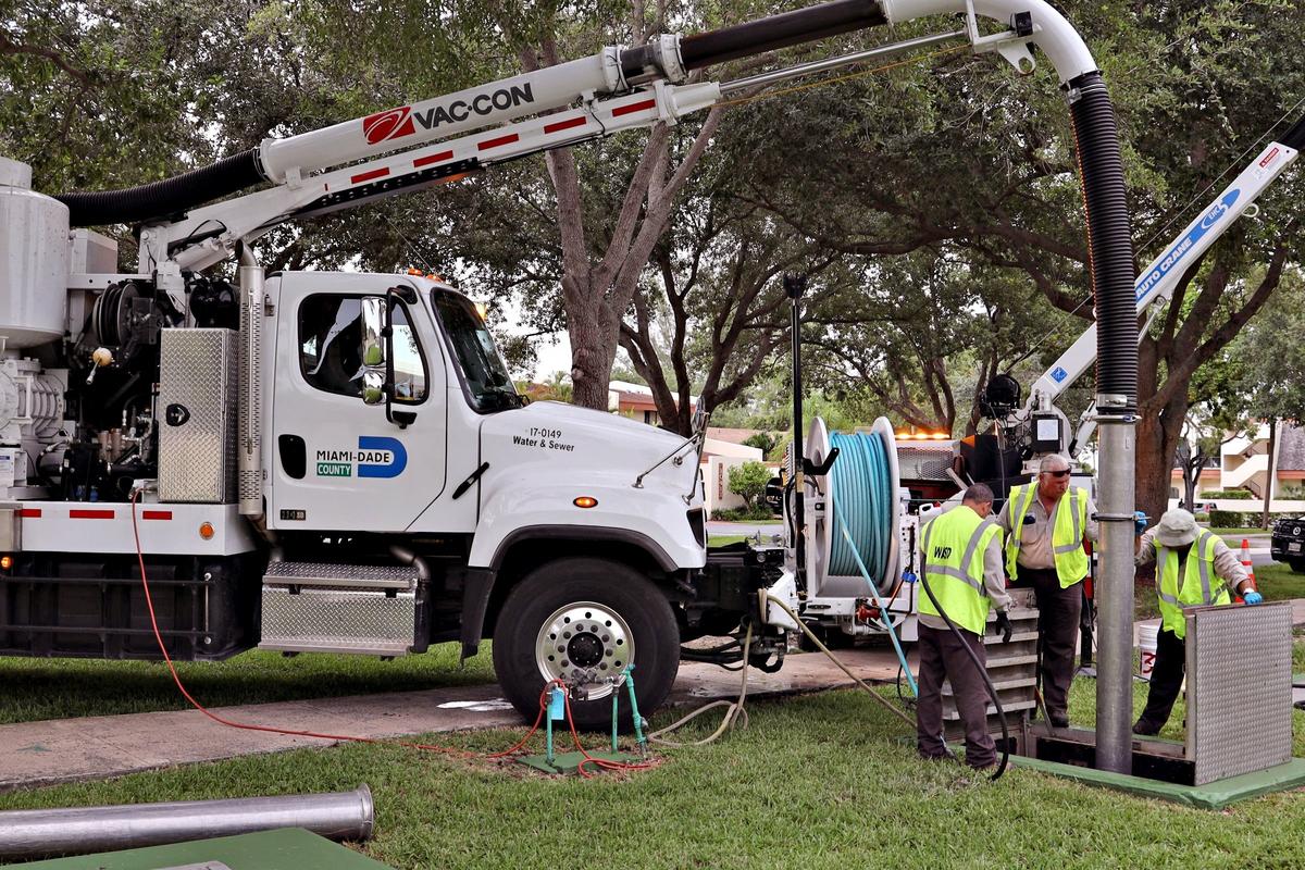 Jose Rodriguez, left, Randy Erion, plant mechanic, and Roberto Diaz, maintenance mechanic, right, use a Vac-Can truck to clean Pump Station 811 in Kendall on Aug. 1, 2019. The Miami-Dade Water and Sewer Department pulls out 300 tons of wipes from its wastewater pump stations and treatment plants each month.