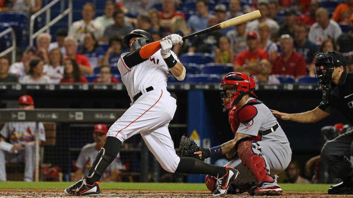 Miami Marlins shortstop Miguel Rojas hits a RBI single during the second inning of a Major League Baseball game against the St. Louis Cardinals at Marlins Park on Wednesday, August 8, 2018.