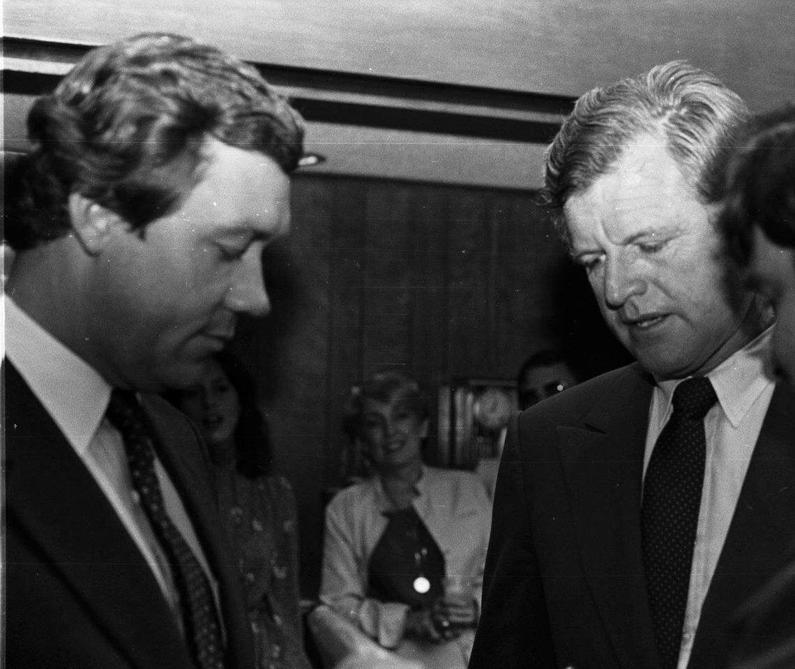 A young George Sheldon huddles with U.S. Sen. Edward Kennedy.