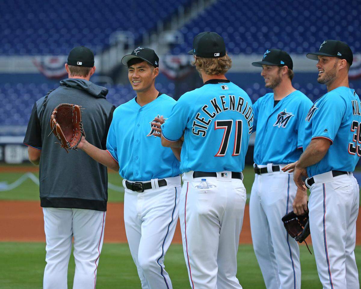From left to right, Miami Marlins pitchers Wei-Yin Chen (20) Drew Steckenrider (71) Adam Conley (61) Tyler Kinley (39) talking during the workout day ahead of Opening Day at the Marlins Park on Wednesday, March 27, 2019 in Miami.