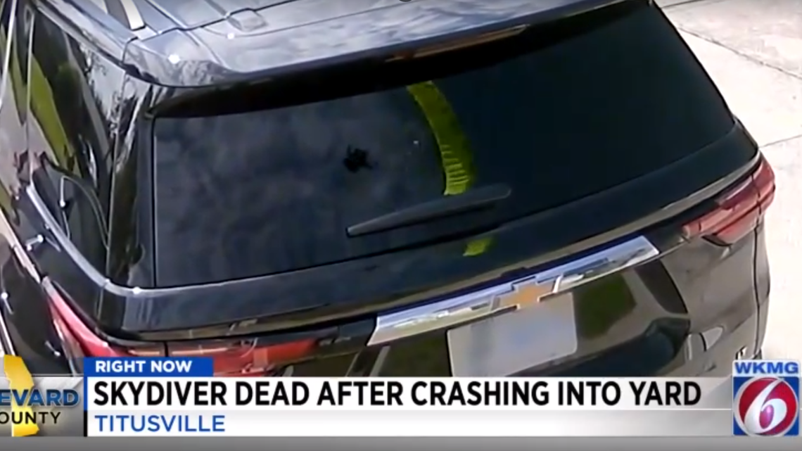 A home’s surveillance footage captured the moments before a skydiver crash landed in a Florida lawn in a reflection on a vehicle’s back window, WKMG reported.