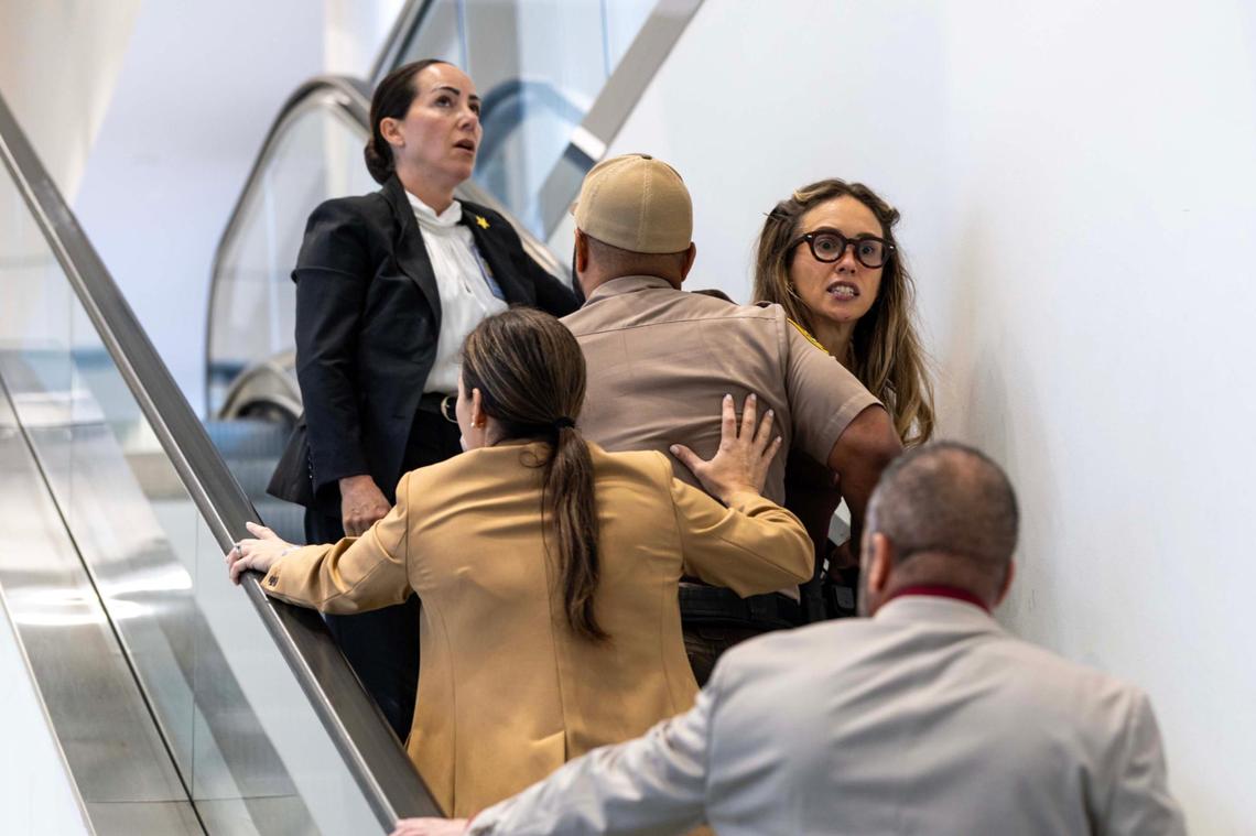 Camila Ramos is forcibly removed from the commission chambers by officers during a Miami-Dade County Commission meeting at the Stephen P. Clark Government Center on Thursday, June 26, 2025, in Miami.