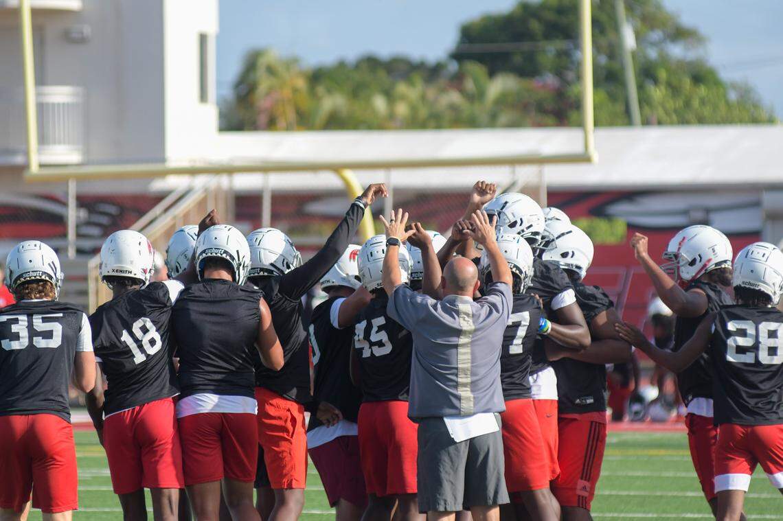 Cardinal Gibbons defensive players huddle together during practice on Monday, Aug. 1, 2021, at Cardinal Gibbons High School in Fort Lauderdale, Florida.