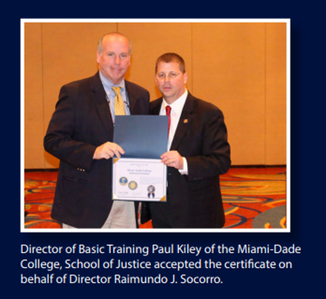 Paul Kiley, director of the Miami Dade College School of Justice, accepts a certificate from the Florida Department of Law Enforcement in 2019.