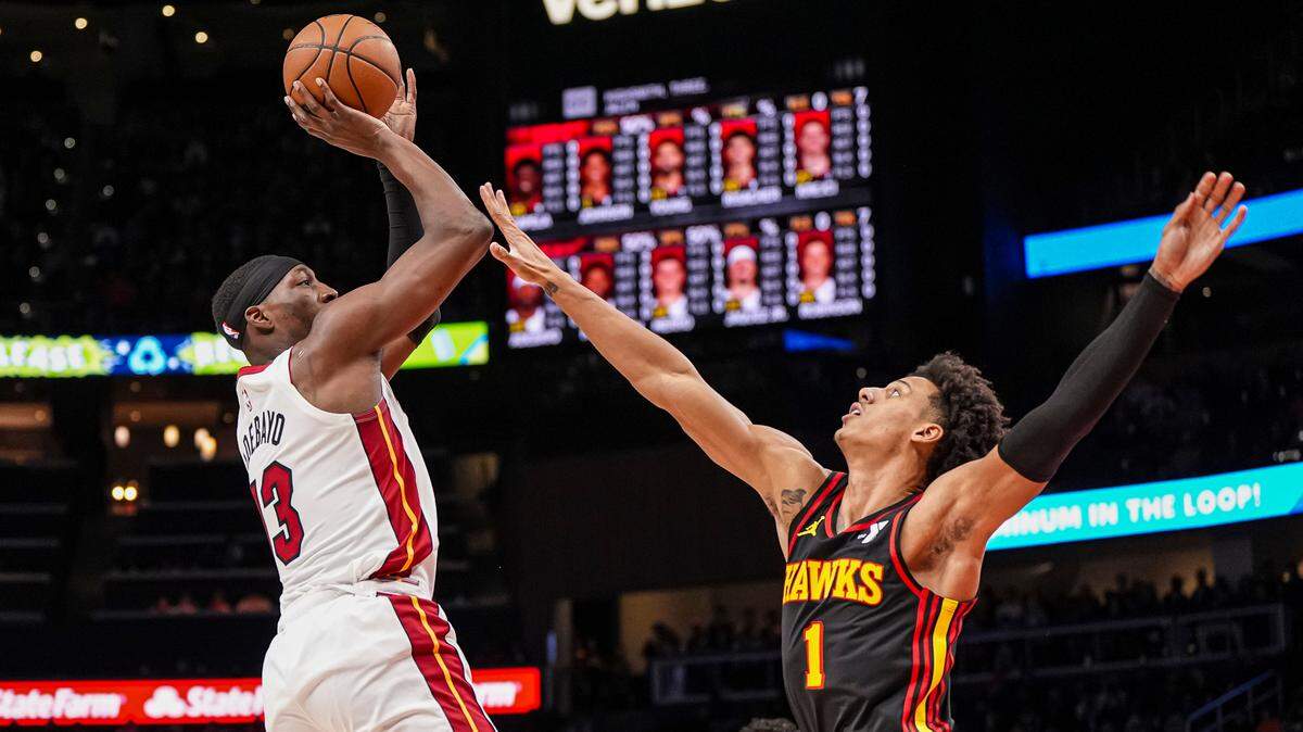 Miami Heat center Bam Adebayo (13) shoots over Atlanta Hawks forward Jalen Johnson (1) during the first half at State Farm Arena.