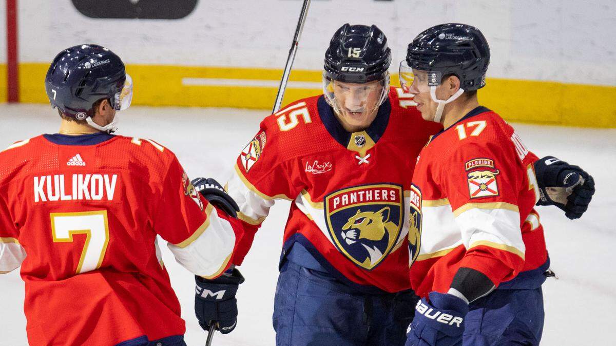 Florida Panthers center Evan Rodrigues (17) celerates his goal with center Anton Lundell (15) and defenseman Dmitry Kulikov (7) during the second period of a hockey game on Thursday, April 11, 2024, at Amerant Bank Arena in Sunrise, Fla.