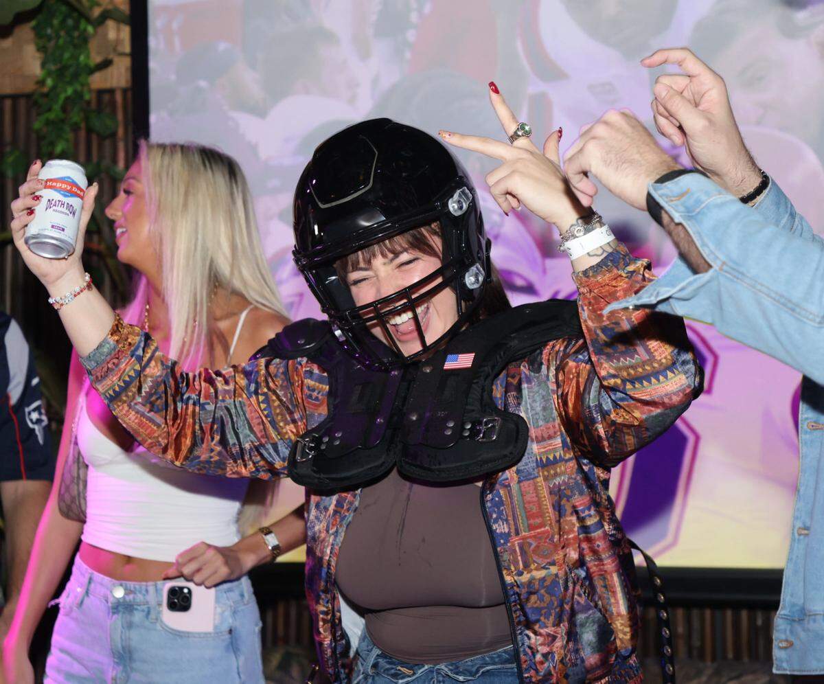 A Super Bowl reveler celebrates after winning on of the many drinking contests during the “Benito Bowl.”