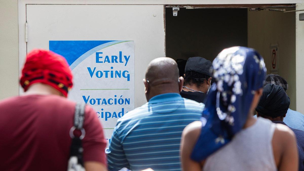 Residents of North Miami line up to vote early at the City of North Miami Public Library on Oct. 26, 2024. 