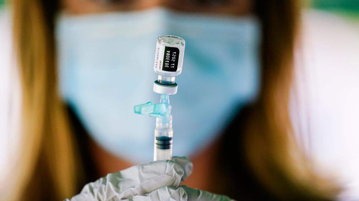 A syringe is prepared with the Pfizer COVID-19 vaccine at a clinic at the Reading Area Community College in Reading, Pa., Tuesday, Sept. 14, 2021. (AP Photo/Matt Rourke)