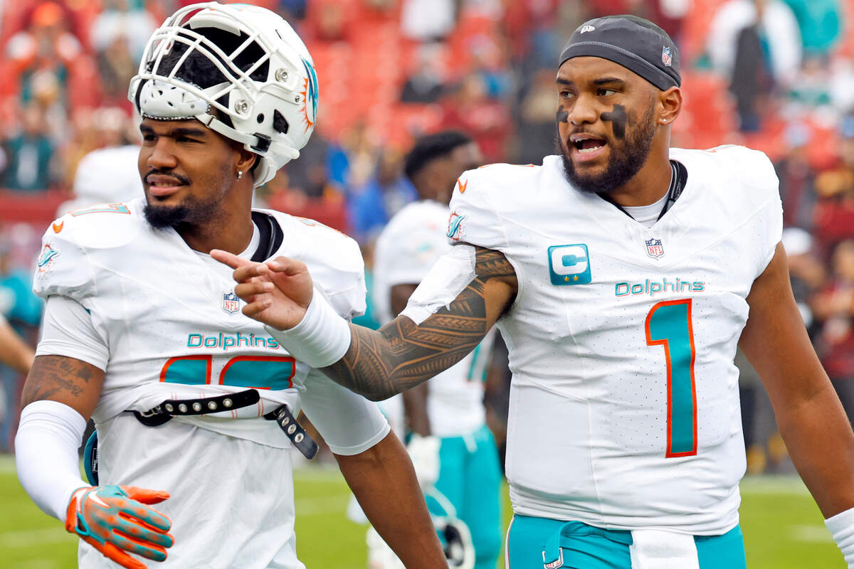 Miami Dolphins quarterback Tua Tagovailoa (1) and wide receiver Jaylen Waddle (17) walk off the field to the locker room after warmups in preperation for the game against the Washington Commanders at FedEx Field in Landover, Maryland on Sunday, December 3, 2023.