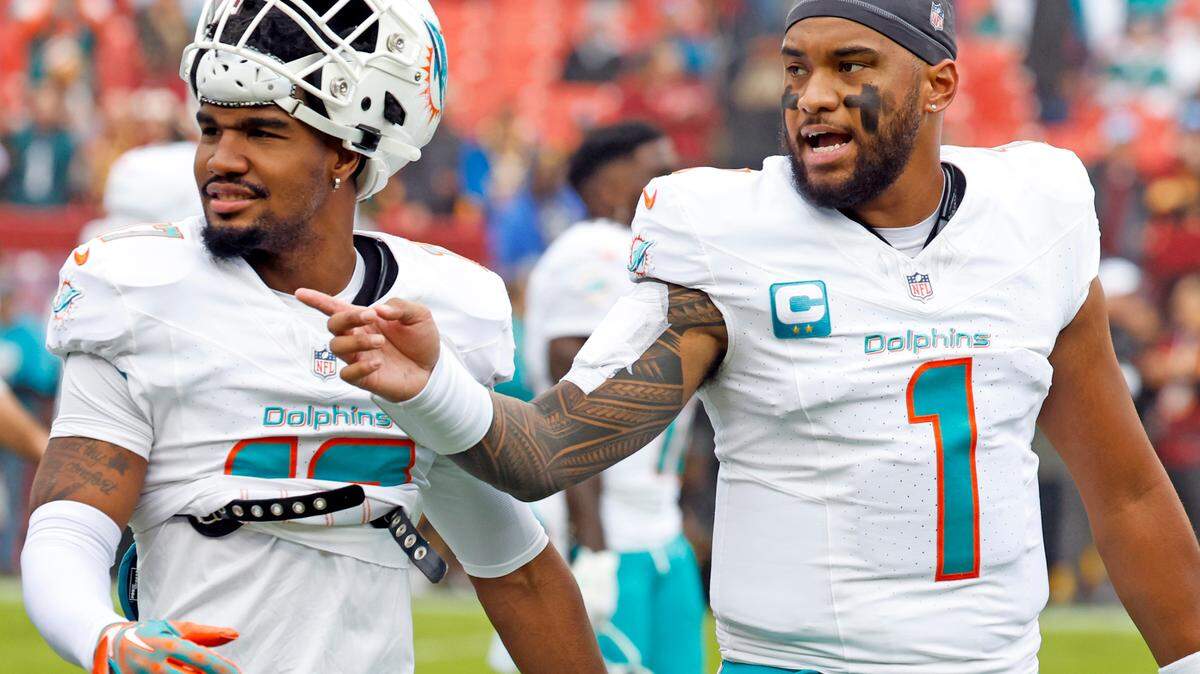 Miami Dolphins quarterback Tua Tagovailoa (1) and wide receiver Jaylen Waddle (17) walk off the field to the locker room after warmups in preperation for the game against the Washington Commanders at FedEx Field in Landover, Maryland on Sunday, December 3, 2023.