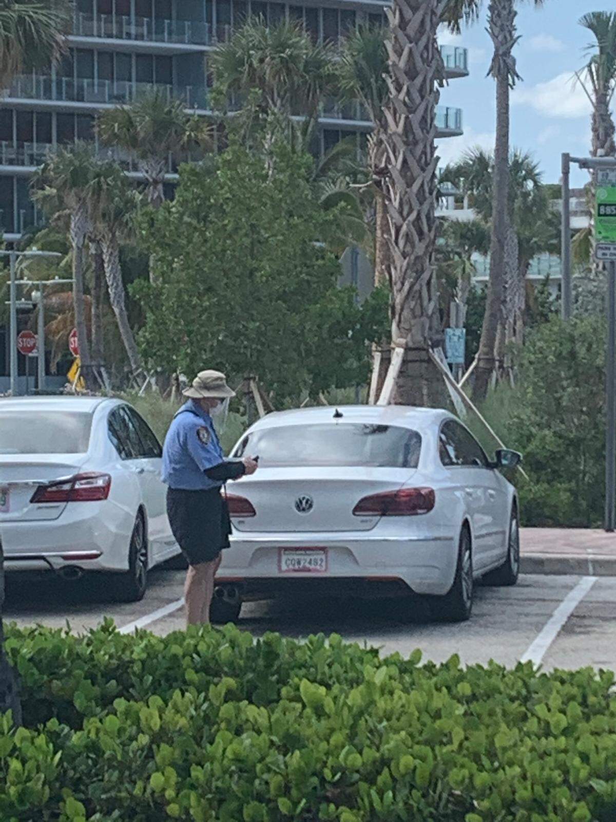 A parking enforcement officer wore a mask while working in Miami Beach on April 2.