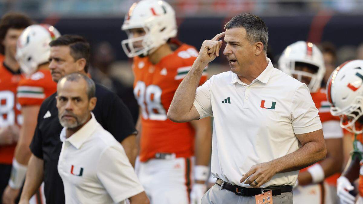 Miami Hurricanes head coach Mario Cristobal gestures during warmups before the NCAA football game against the NC State Wolfpack at Hard Rock Stadium in Miami Gardens, Florida, on Saturday, November 15, 2025.