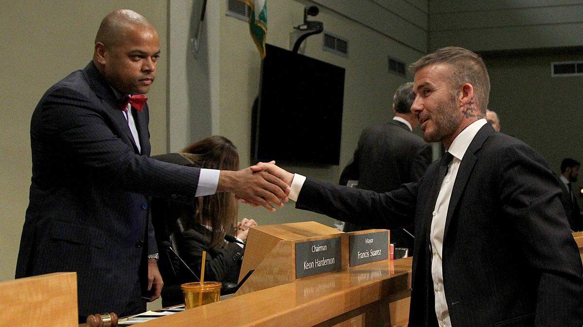Commissioner Keon Hardemon, left, shakes hands with David Beckham during a 2018 public hearing on bringing a Major League Soccer stadium to Miami. Hardemon’s aunt was a lobbyist for Beckham’s ownership group.
