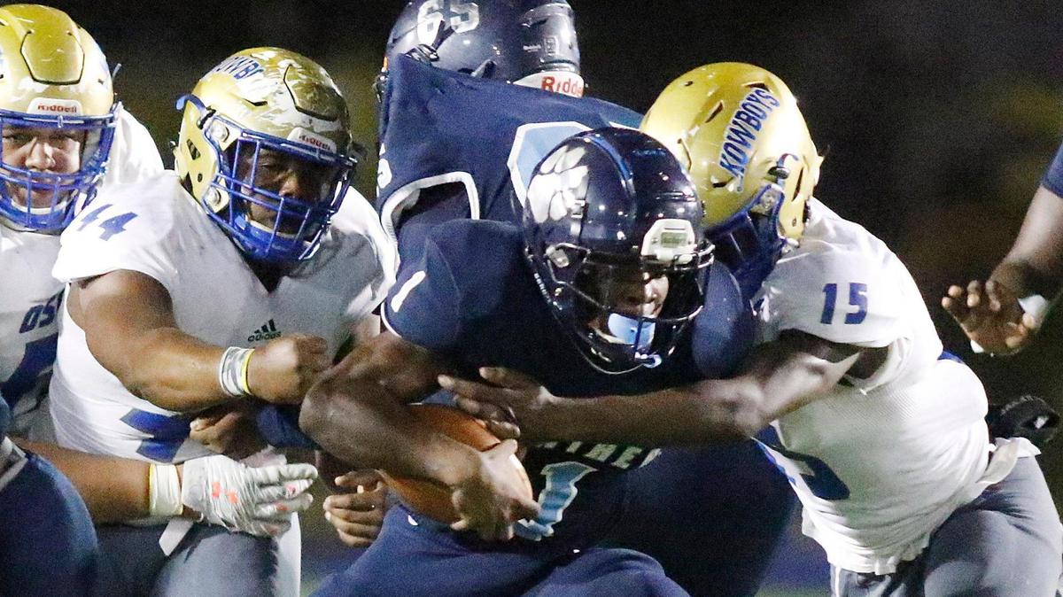 Palmetto Panthers Brashard Smith (1) tries to break free during the FHSAA Class 8A state semifinal football game against Osceola Kowboys on Saturday, December 12, 2020 at Traz Powell stadium in Miami