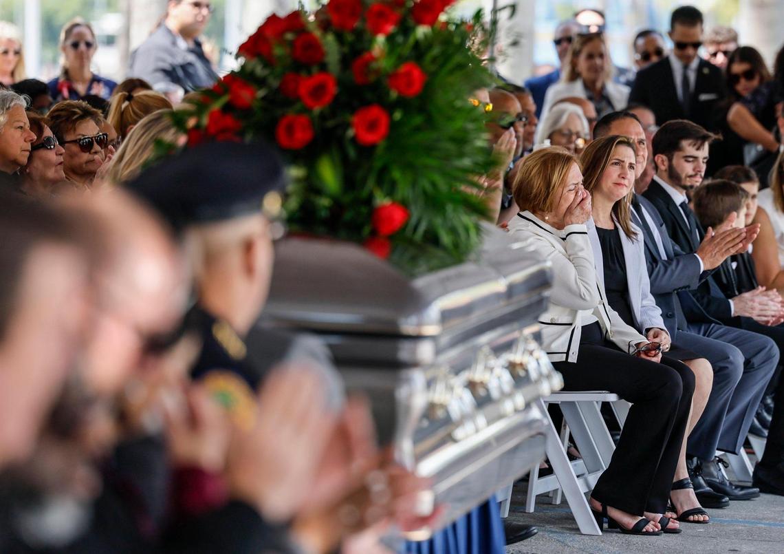 Chacha Reyes, the wife of Miami City Commissioner Manolo Reyes, who died on Thursday, reacts during a memorial service at Miami City Hall on Wednesday, April 16, 2025. Seated next to her is daughter Meily Reyes.